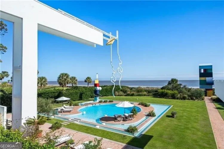 A house overlooking the ocean, with a pool.