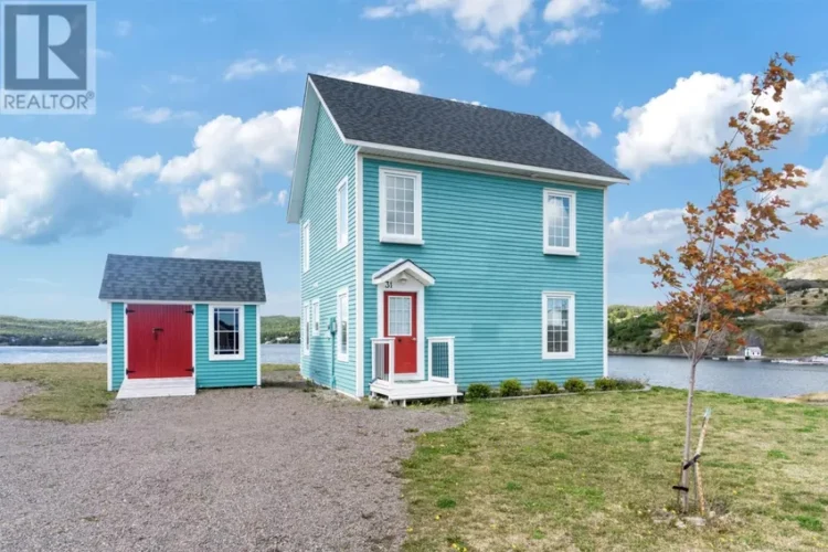 A blue house featuring two red doors.