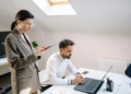 couple calculating finances in home office