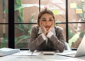 A woman looks frustrated while looking at her computer