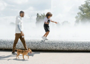 Dad and daughter walking dog