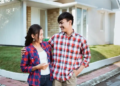 couple standing outside of home