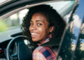 A woman sitting in the driver's seat of a car
