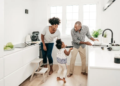 couple dancing in kitchen with child