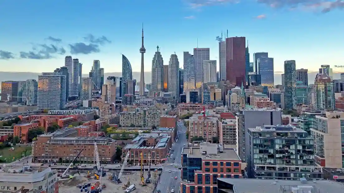 Aerial view of Toronto showcasing its skyline, including iconic buildings and the waterfront.