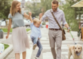 parents, child, and dog walking outside