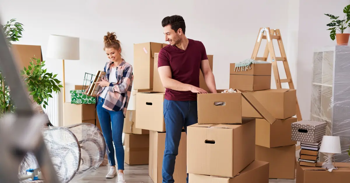 two people packing to move out