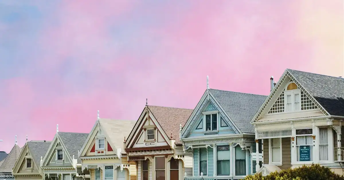 houses in front of a pink and blue sky