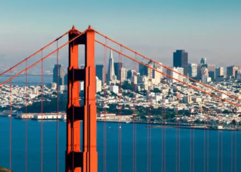 Aerial view of the Golden Gate Bridge and San Francisco in the background.