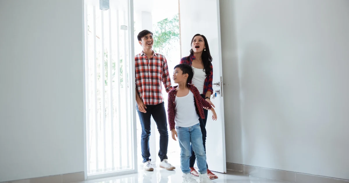 A family walks into a house and looks amazed.