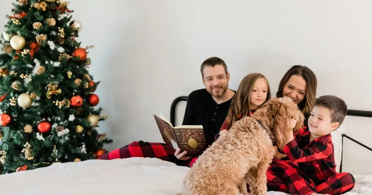 family reading together in bed with dog