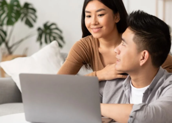 a couple looking at a laptop