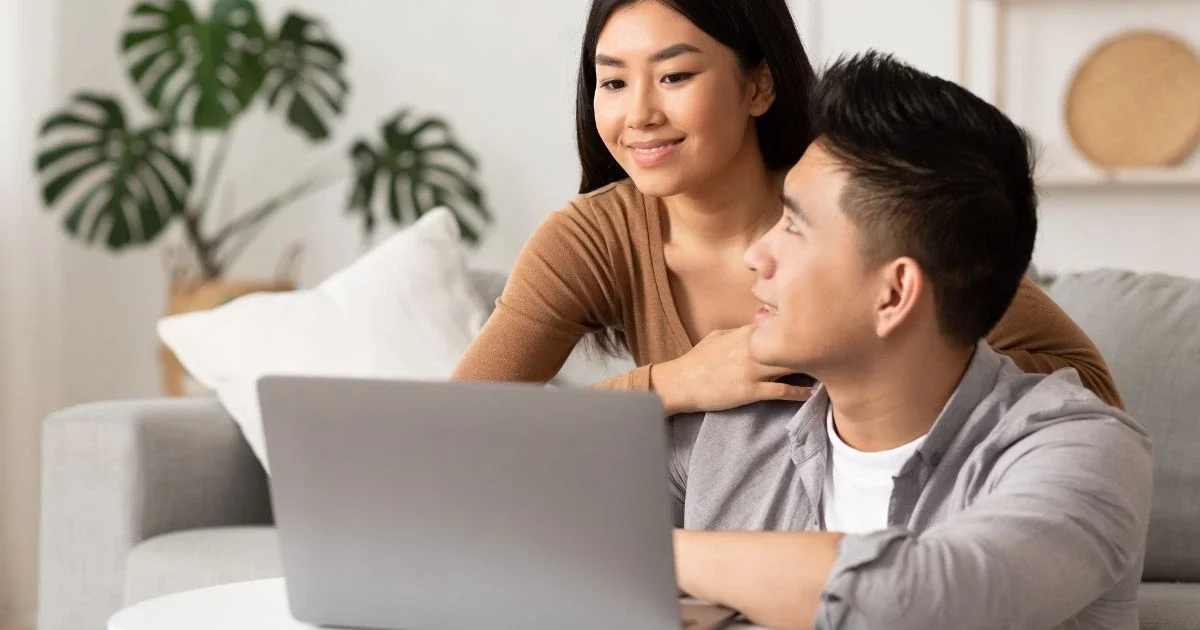 a couple looking at a laptop