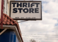 Thrift store sign displayed on the exterior of a building, indicating a secondhand shopping location.