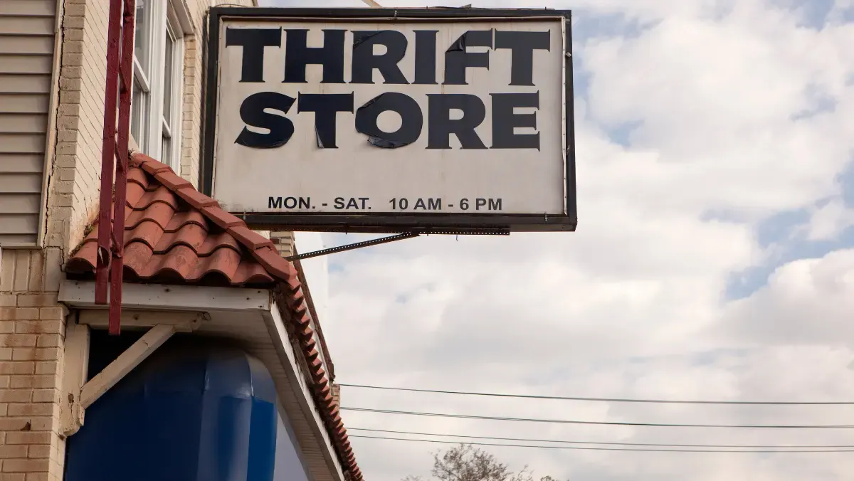 Thrift store sign displayed on the exterior of a building, indicating a secondhand shopping location.