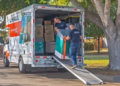 Two Moving Help moving labor providers carefully load a washing machine into a U-Haul truck rental.