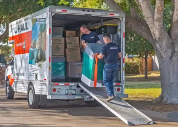 Two Moving Help moving labor providers carefully load a washing machine into a U-Haul truck rental.
