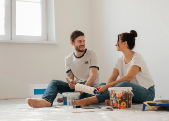 couple sitting in a room painting together