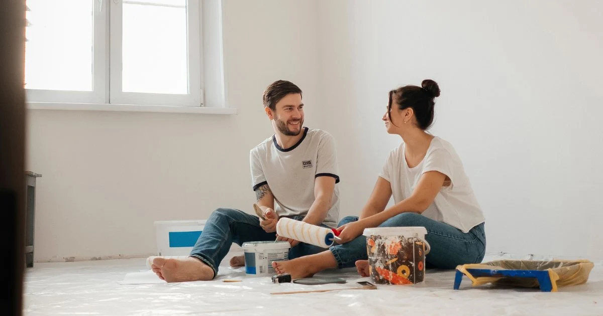 couple sitting in a room painting together