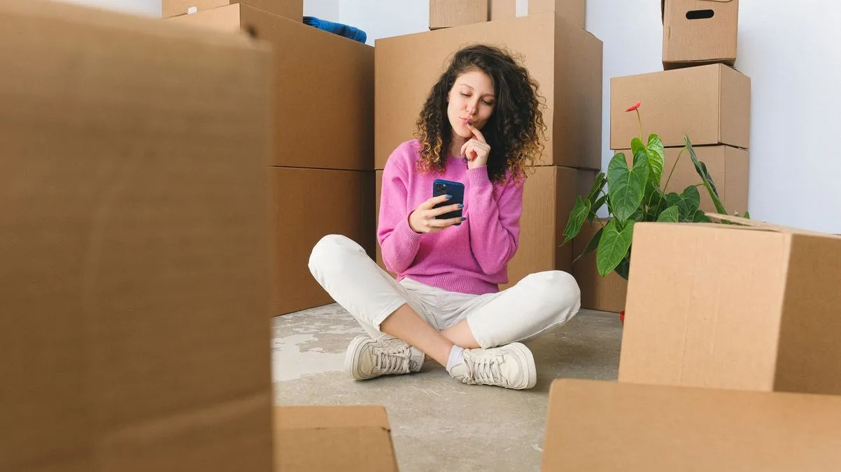single woman searching for home on phone
