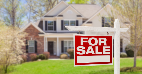 House with for sale sign.