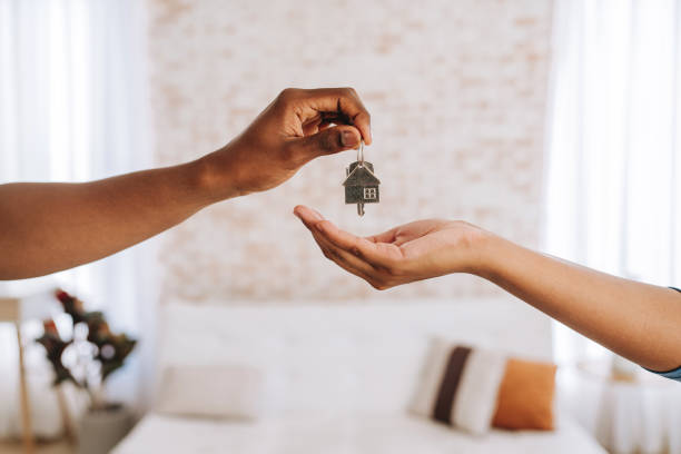 Real estate agent giving the keys to a new home