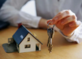 keys and miniature home figure