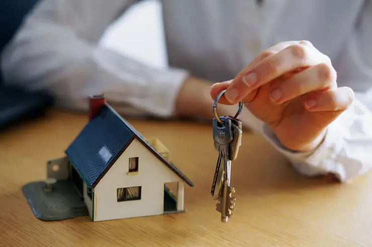 keys and miniature home figure
