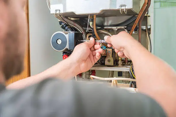person fixing furnace